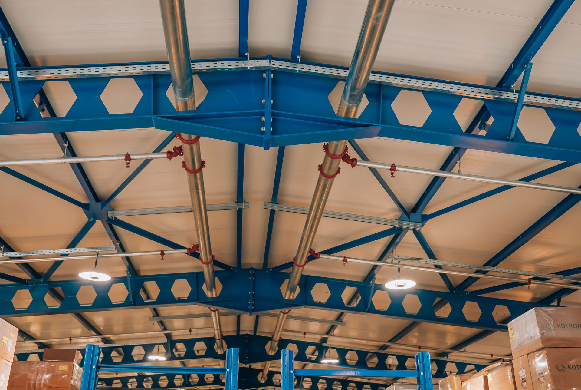 Fabricated castellated sections arranged in an industrial workshop